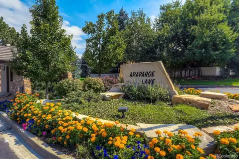 a view of a garden with flowers and trees
