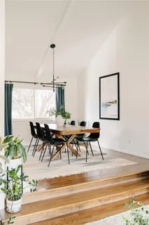 a dining room with furniture and a window