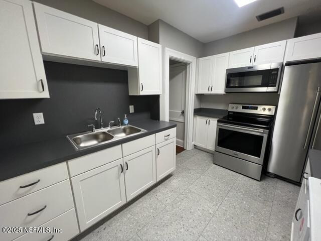 2144 Southampton Road Jacksonville, FL 32207 - Photo 7 of 27 a kitchen with granite countertop a sink stainless steel appliances and cabinets