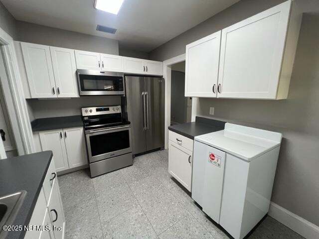 2144 Southampton Road Jacksonville, FL 32207 - Photo 8 of 27 a kitchen with a refrigerator sink and cabinets