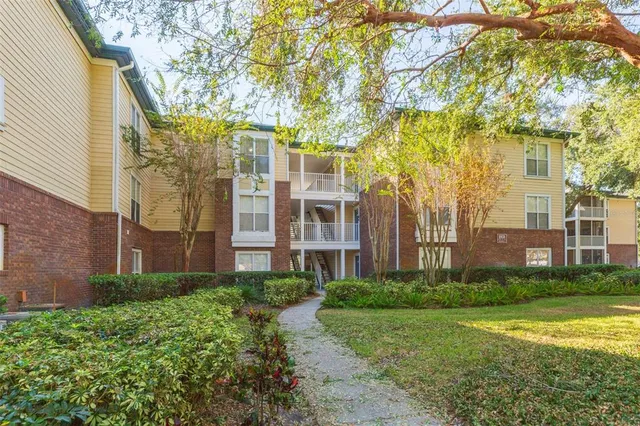 a view of a brick building next to a yard