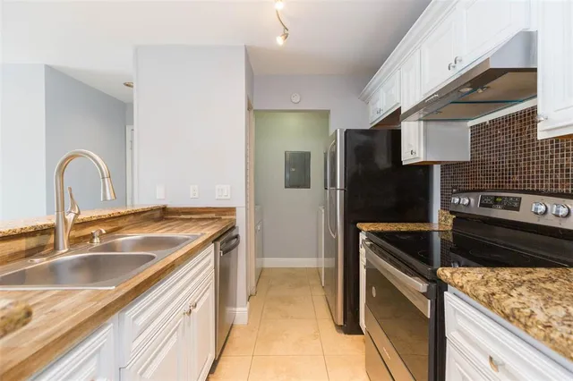 a kitchen that has a sink and a stove