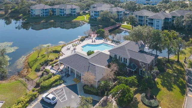 an aerial view of a house with outdoor space and lake view