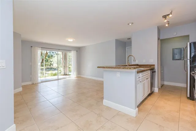 a kitchen with a stove a sink a counter top space and cabinets