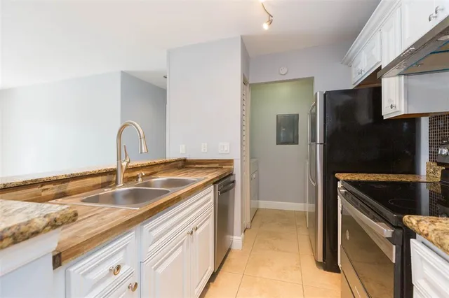 a kitchen with a refrigerator and a sink