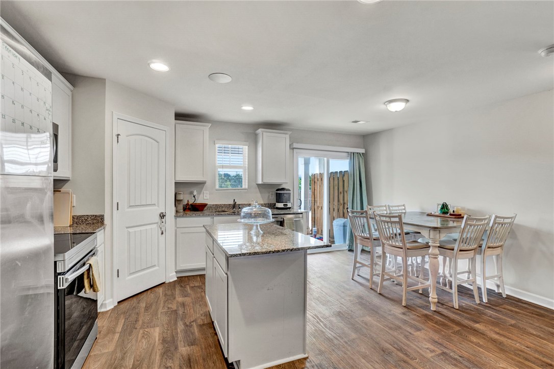 221 Samuel Street Pendleton, SC 29670 - Photo 12 of 34 This bright kitchen and dining area features warm flooring and convenient outdoor access.