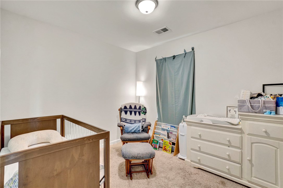 221 Samuel Street Pendleton, SC 29670 - Photo 22 of 34 This cozy nursery offers a comfortable and serene space for rest and care.