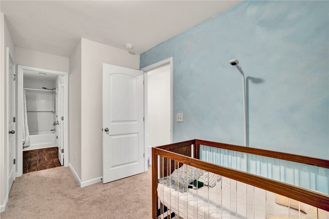 221 Samuel Street Pendleton, SC 29670 - Photo 23 of 34 This cozy bedroom features warm carpeting and convenient access to a full bathroom.