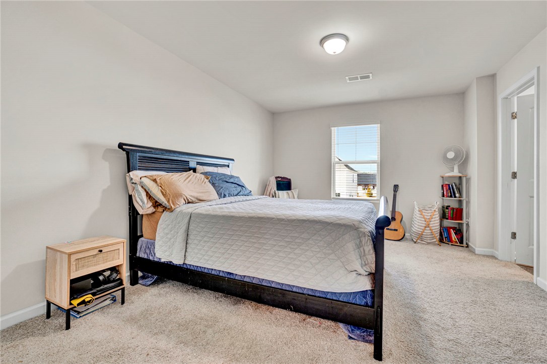221 Samuel Street Pendleton, SC 29670 - Photo 24 of 34 This cozy bedroom offers soft carpeting and a window for natural light.
