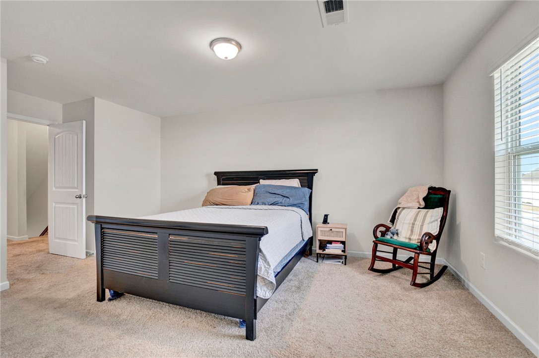 221 Samuel Street Pendleton, SC 29670 - Photo 25 of 34 This cozy bedroom provides a comfortable retreat with soft carpet and natural light from the window.