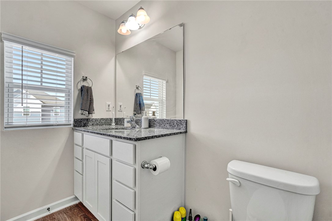 221 Samuel Street Pendleton, SC 29670 - Photo 27 of 34 This bright bathroom features a vanity with granite counters and durable wood flooring.