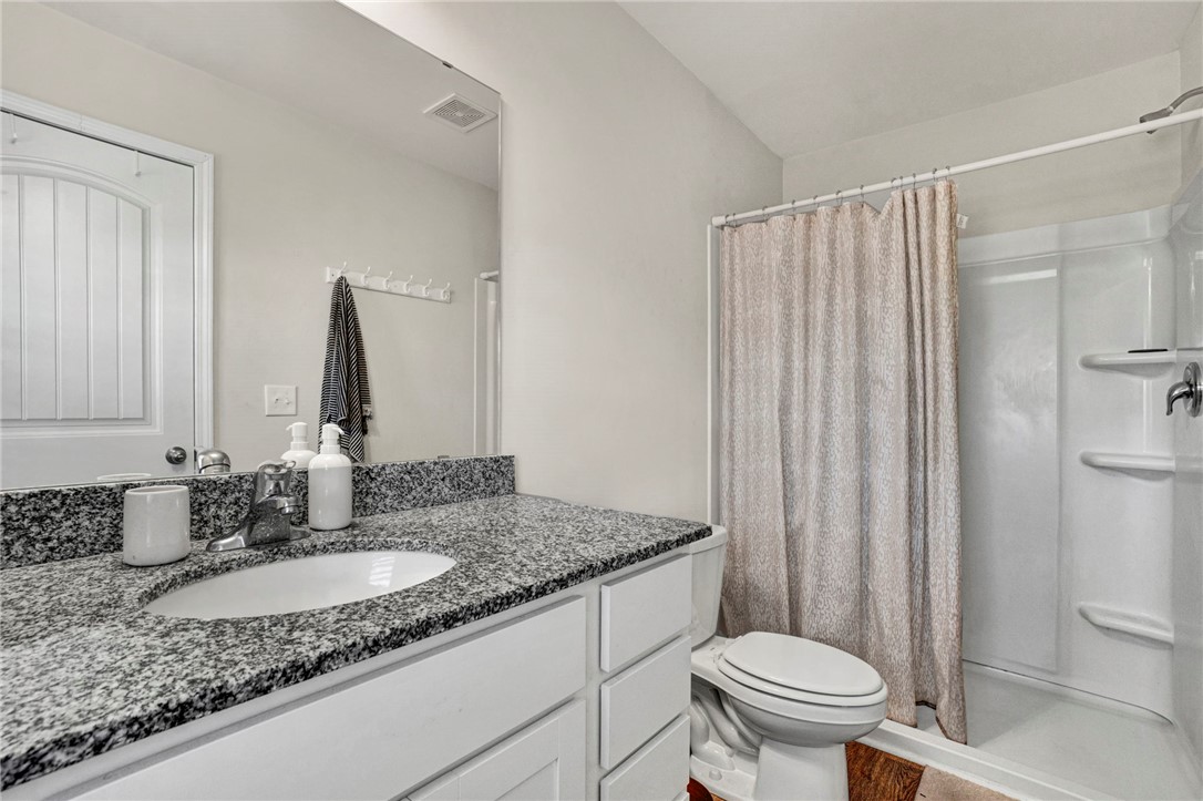 221 Samuel Street Pendleton, SC 29670 - Photo 28 of 34 This bathroom features a sleek vanity with ample counter space and a convenient shower.