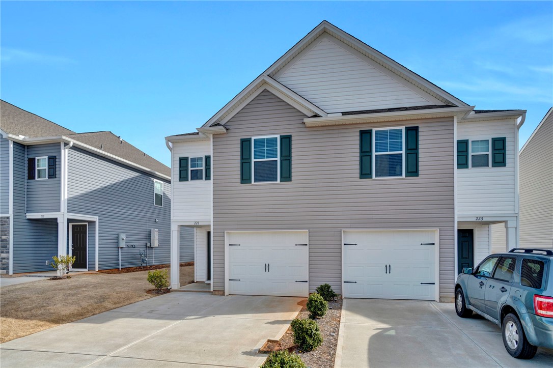221 Samuel Street Pendleton, SC 29670 - Photo 3 of 34 This modern multi-story dwelling features durable siding and practical garage access, ideal for comfortable living.