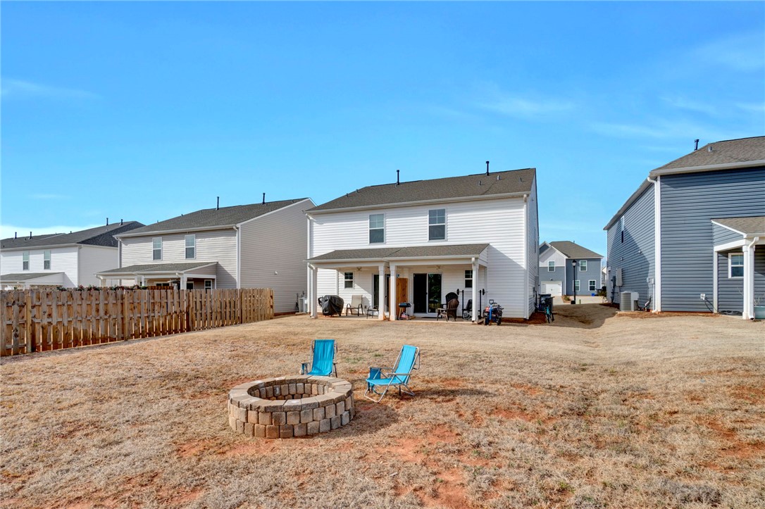 221 Samuel Street Pendleton, SC 29670 - Photo 31 of 34 This spacious backyard with a fire pit offers a perfect outdoor retreat for gatherings.