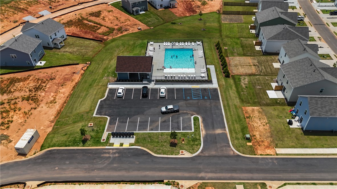 221 Samuel Street Pendleton, SC 29670 - Photo 32 of 34 This aerial view showcases a vibrant community pool with surrounding homes and ample parking.