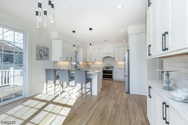 a kitchen with stainless steel appliances kitchen island granite countertop a sink and cabinets