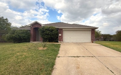 Ranch-style house featuring a front lawn, concrete driveway, brick siding, and a garage