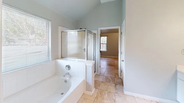 a bathroom with a bathtub and a shower