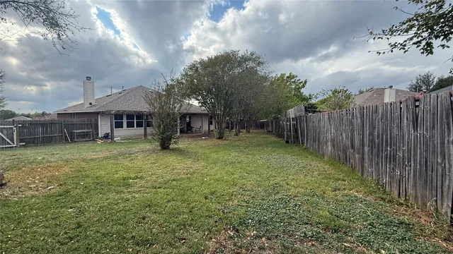 a view of a house with backyard and porch