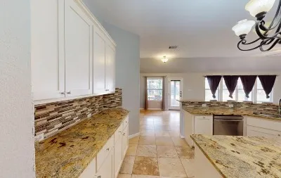 a view of a kitchen with wooden floor and cabinets