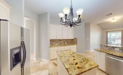 a bathroom with a granite countertop sink a toilet and a mirror