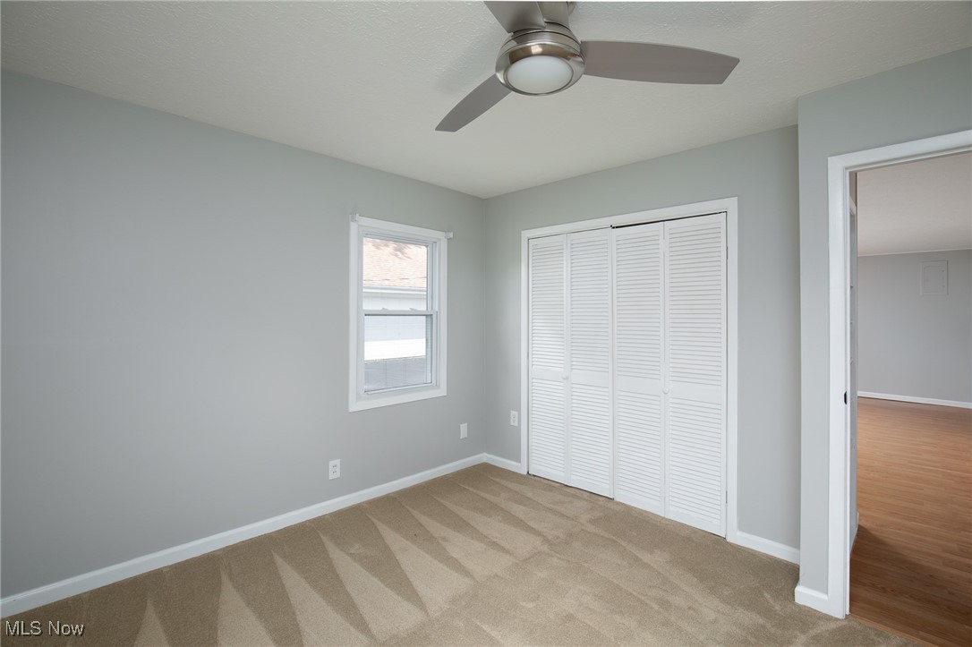 4782 Belle Meadow Road Mentor, OH 44060 - Photo 16 of 22 Unfurnished bedroom featuring ceiling fan, light colored carpet, and a closet