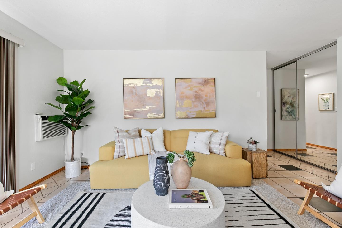 a living room with furniture and a potted plant