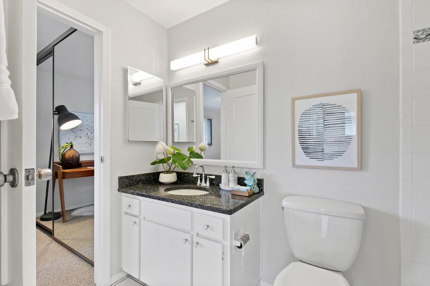 108 East Middlefield Road, Unit D Mountain View, CA 94043 - Photo 14 of 23 a bathroom with a granite countertop sink a toilet and a mirror