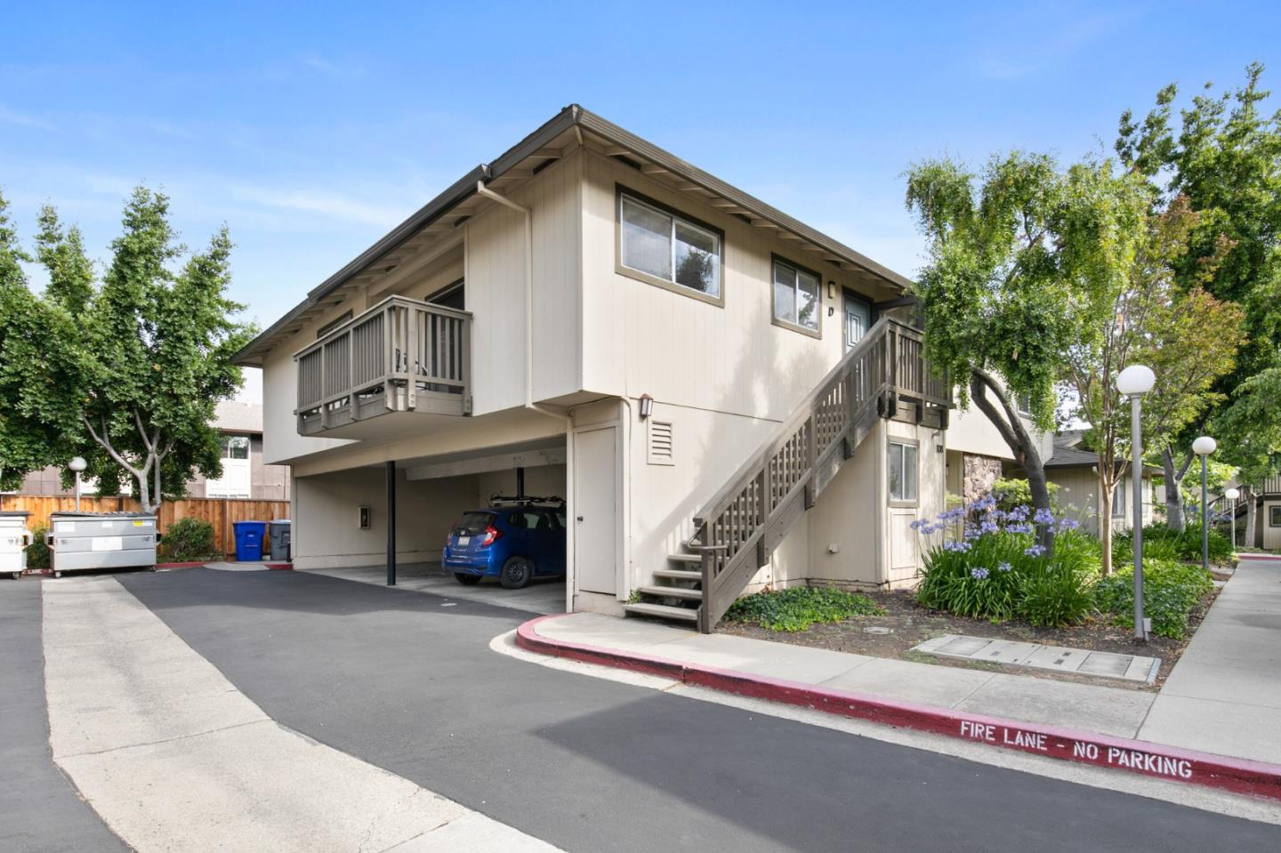 108 East Middlefield Road, Unit D Mountain View, CA 94043 - Photo 22 of 23 a front view of a house with a yard and a garage