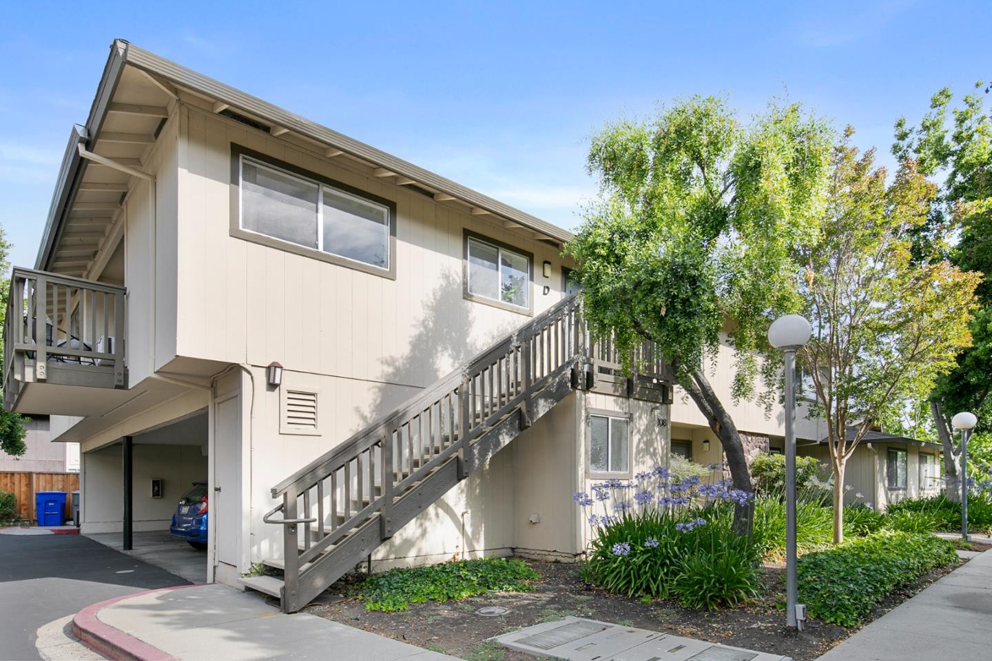 108 East Middlefield Road, Unit D Mountain View, CA 94043 - Photo 23 of 23 a front view of a house with a yard