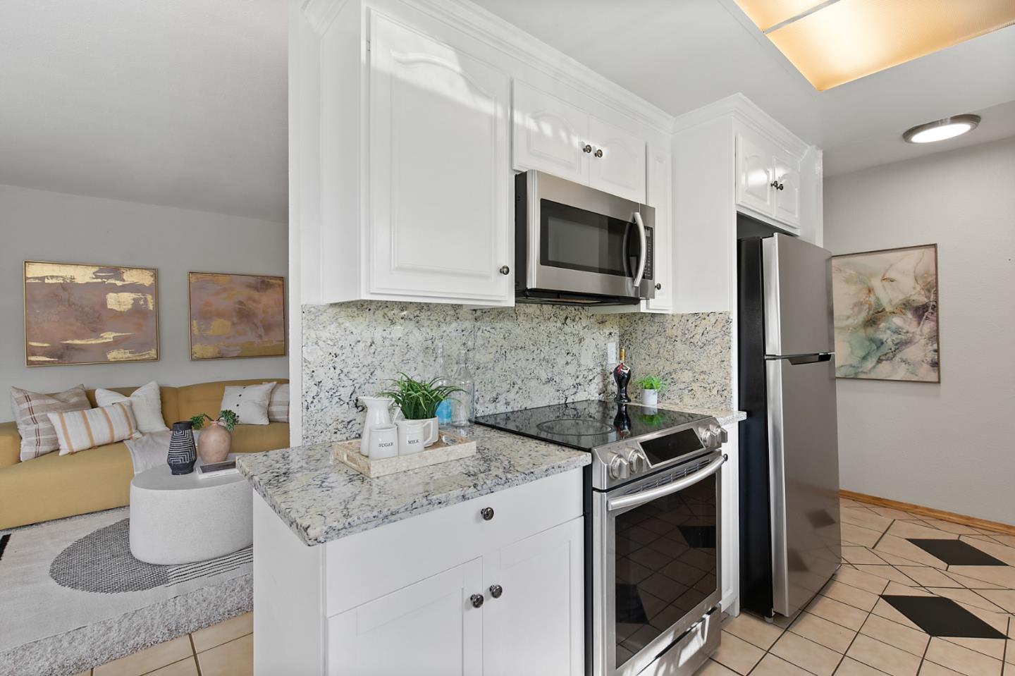 108 East Middlefield Road, Unit D Mountain View, CA 94043 - Photo 6 of 23 a kitchen with stainless steel appliances kitchen island granite countertop a stove a sink and a microwave