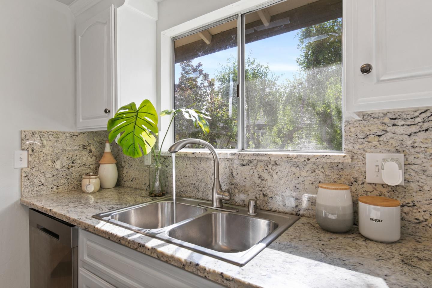 108 East Middlefield Road, Unit D Mountain View, CA 94043 - Photo 9 of 23 a kitchen with a granite countertop sink and a granite counter next to a window