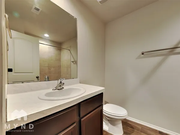 a bathroom with a sink toilet and a mirror