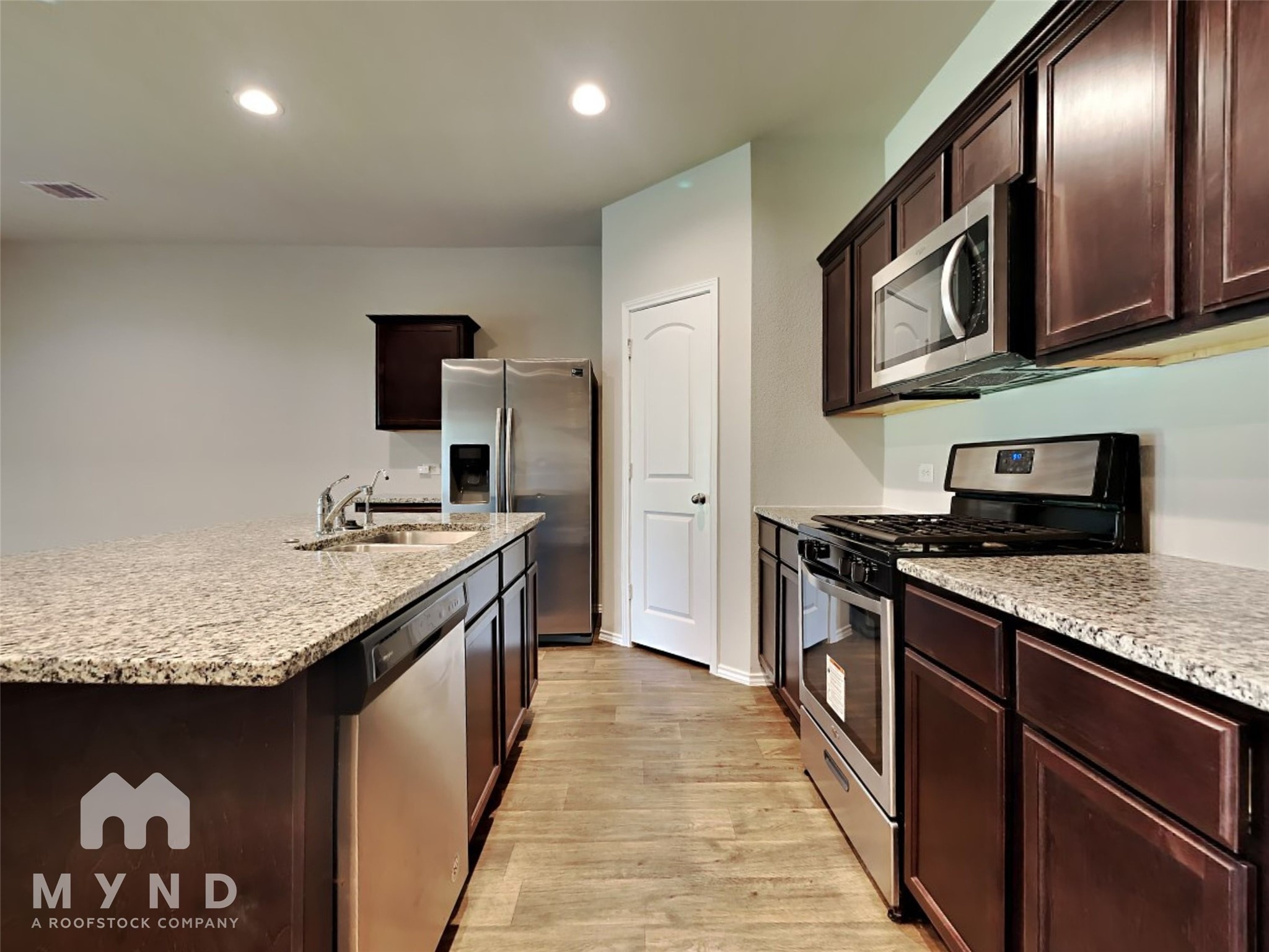 23711 Blodgett Peak Trail Spring, TX 77373 - Photo 2 of 32 a kitchen with stainless steel appliances granite countertop a stove and a sink