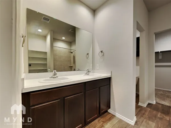 a bathroom with a double vanity sink and mirror