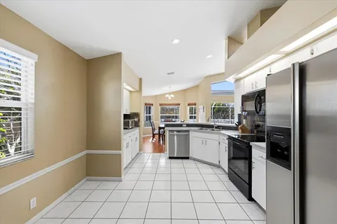 a kitchen with a sink stainless steel appliances and cabinets