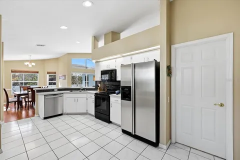 a kitchen with a refrigerator and a sink