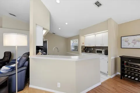 a view of kitchen with sink microwave and refrigerator