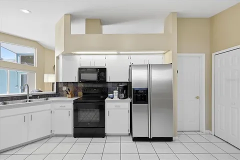 a kitchen with a sink stainless steel appliances and cabinets