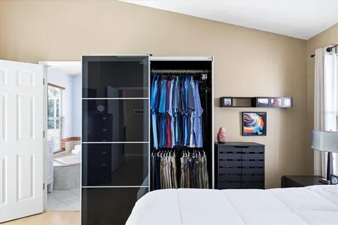 a bedroom with a bed and walk in closet