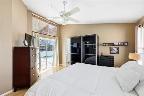 a bedroom with a large bed and a chandelier