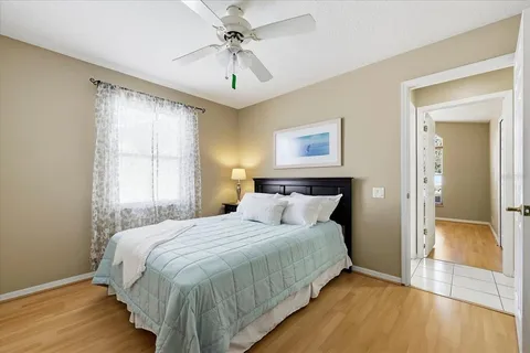 a bedroom with a large bed and a chandelier