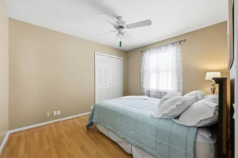 a bedroom with a bed and a ceiling fan