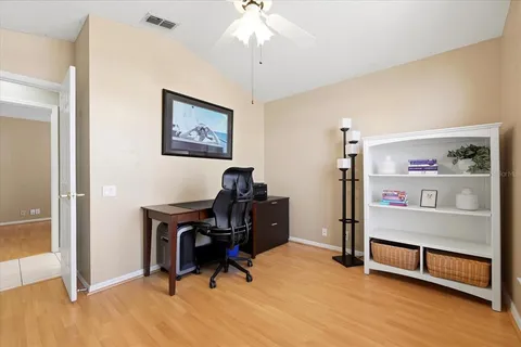 a view of a workspace with furniture and a bedroom