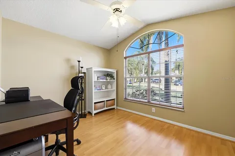 a view of a workspace with furniture and a window