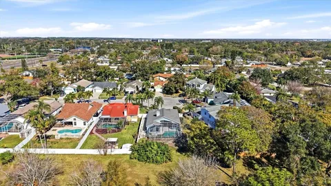 a view of a house with a small yard and wooden fence
