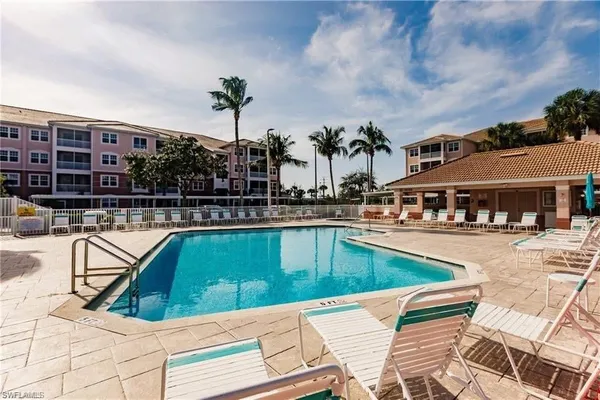 a view of a swimming pool with outdoor seating
