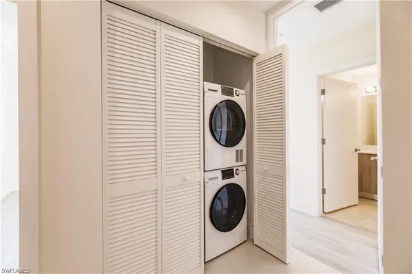 a bedroom with two beds and a large window
