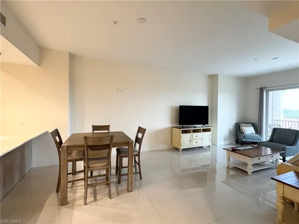 a view of a livingroom with furniture and a flat screen tv