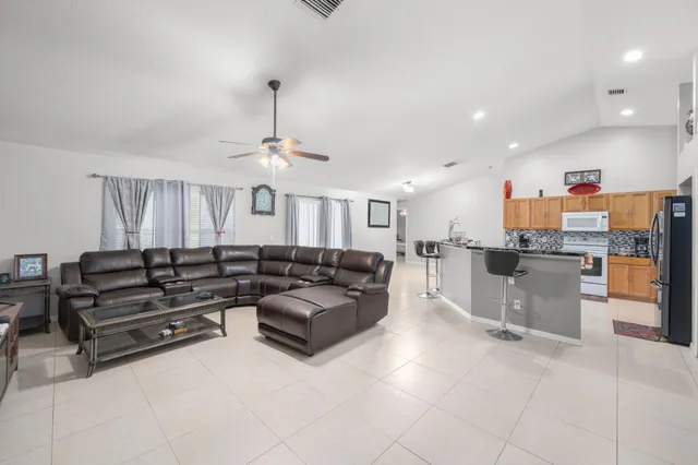 a living room with furniture and kitchen view